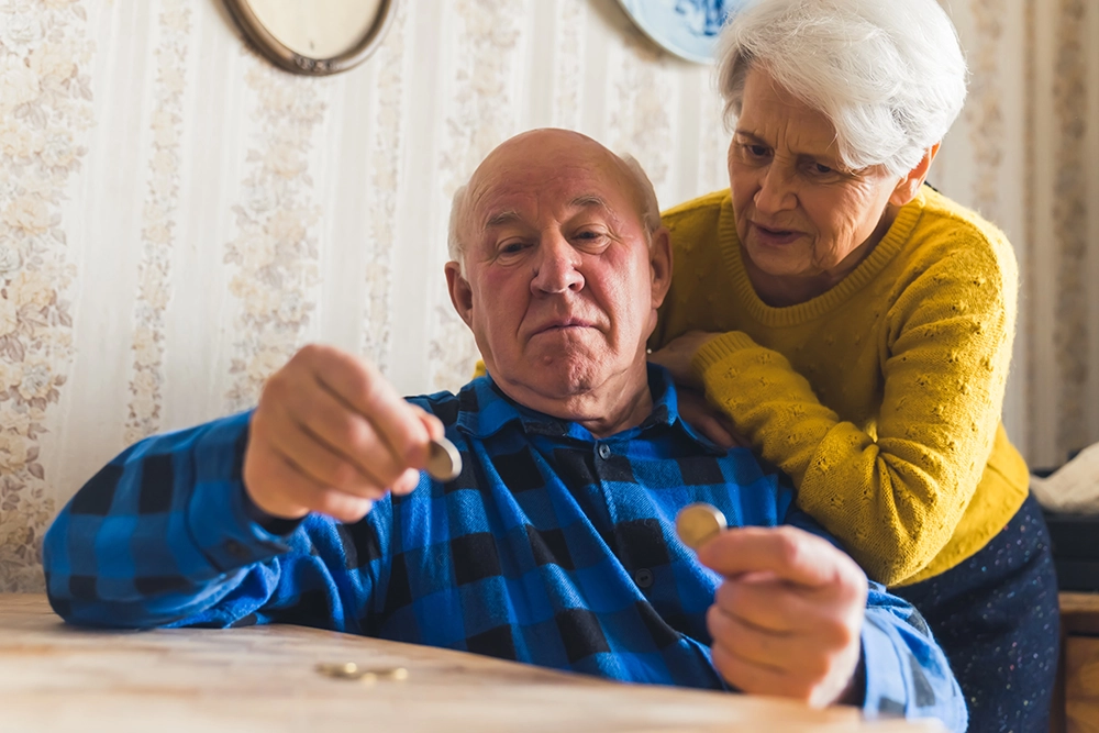 Elderly couple counting change.