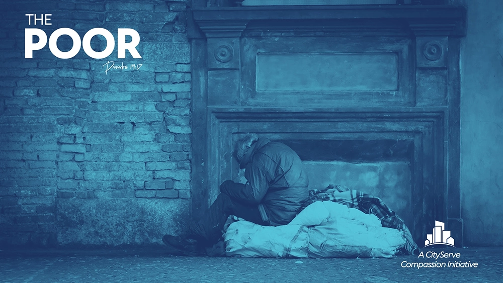 A poor man sitting on the floor.
